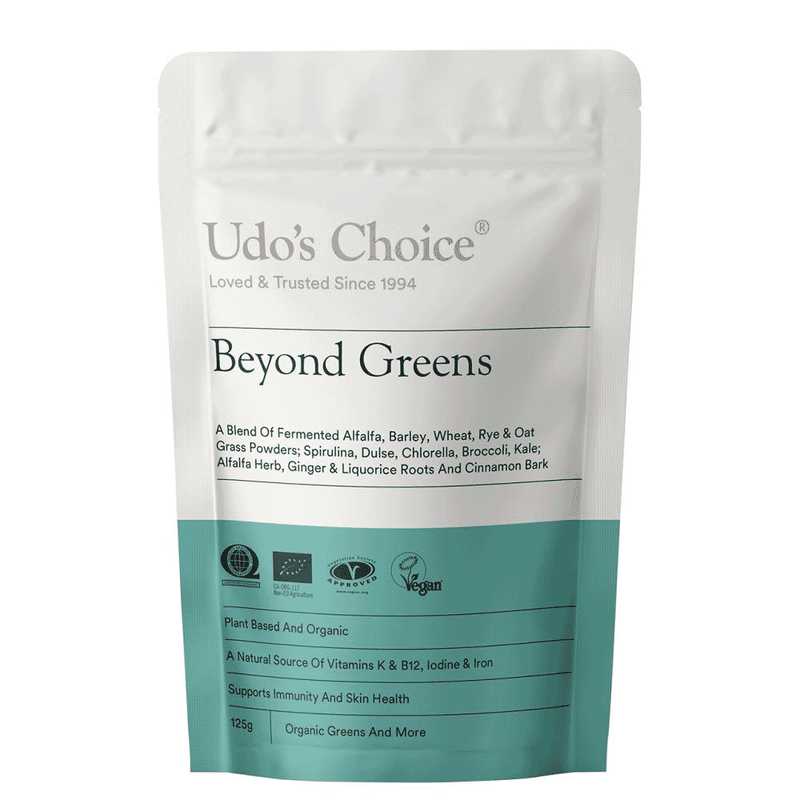 Udo's Choice Beyond Greens 125g jar showing a close-up of the label and the green powder supplement inside.