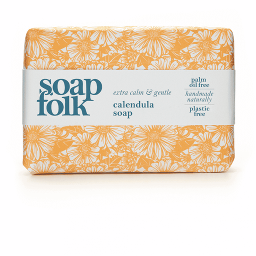 Soap Folk Calendula Soap 105g with visible fresh calendula flower petals and a creamy soap bar on a neutral background.